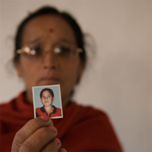 Putali Chaulagain, Subhadra's mother, holds a photograph of her daughter (c) Nick Hogg